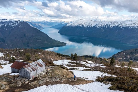 Hiker looking over the Sognefjord, half way up to Mt. Molden, Norway, Europe