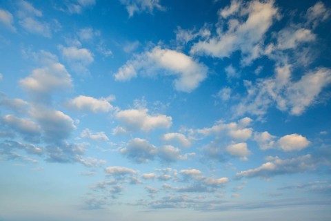 Fleecy clouds adorn the blue evening sky