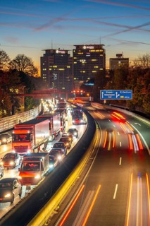Evening traffic, partly with traffic jams, slow-moving traffic on the A40 motorway, Essen skyline,
