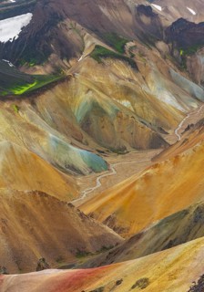 Small river between colourful rhyolite mountains, volcanic landscape, erosion landscape, view from