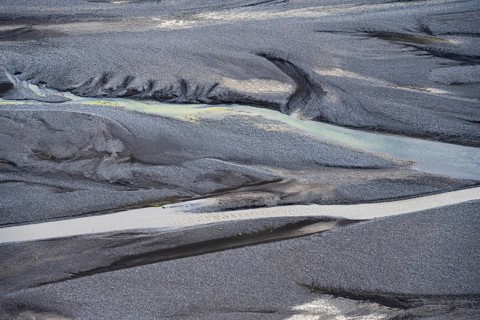 Detail, structure, river course in a gravel bed with black sand, meandering river, Dímonarhellir,