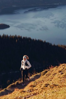 Trail running in autumn on the Jochberg on Lake Walchensee against the wonderful backdrop of the