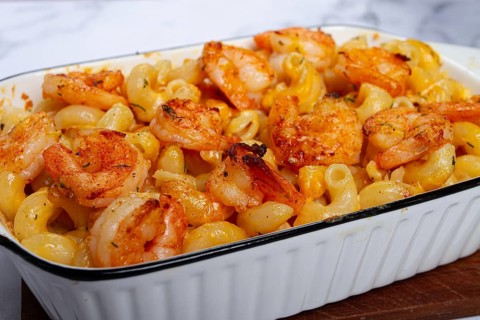 Pasta with shrimp and cheese, with a golden crust, cooked in a baking dish, homemade, no people
