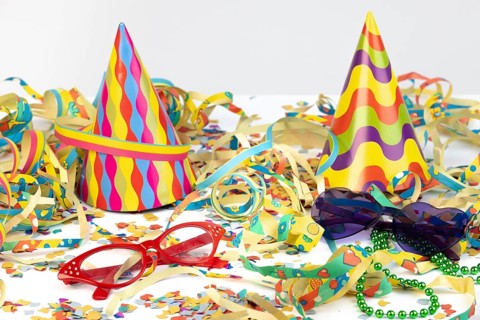 Colourful party hats with glasses and streamers as festive decoration, carnival