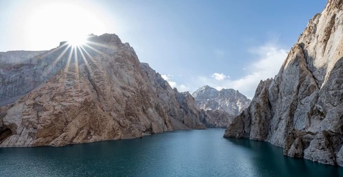 Mountain lake Kol Suu rocky steep mountains, sun star, Kol Suu Lake, Kurumduk Valley, Sary Beles