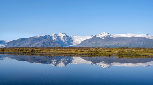 Lake with reflection, view of glacier tongues Skaftafellsjökull and Svínafellskökull, glaciated