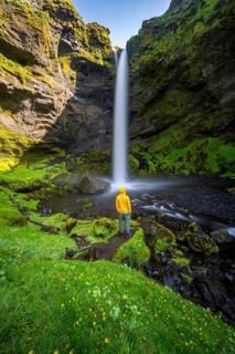 Tourist at Kvernufoss waterfall, in summer when the weather is nice, gorge and river, long