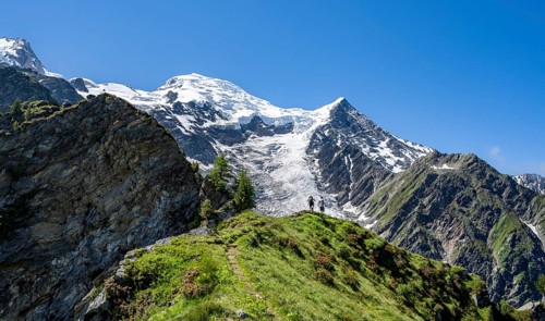 Mountaineer on a hiking trail in front of mountain landscape with glacier, view of glacier Glacier