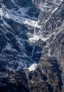 Waterfall of snow on a rock face, Watzmann east face in autumn with snow, Berchtesgaden National