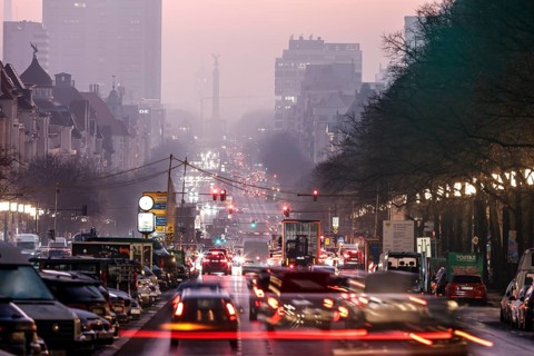 Busy Kaiserdamm and Bismarckstraße during morning rush hour in foggy and cloudy winter weather,