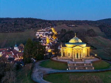 Burial chapel on the Württemberg at night on a hill with village lights, illuminated,