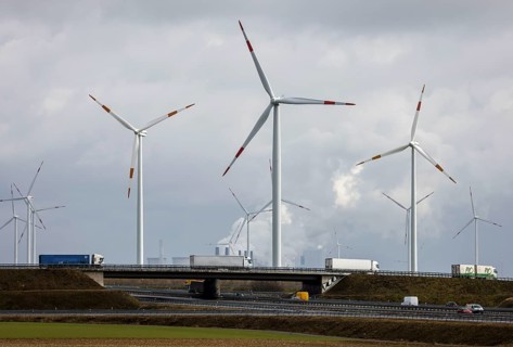 Grevenbroich, North Rhine-Westphalia, Germany - Truck on motorway and wind farm in front of RWE