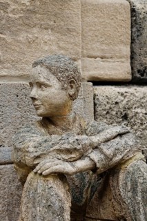 Sculpture in front of the old school building, art in public space, stone figure, sculpture by the