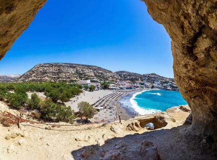 View from the rock caves to the beach of Matala, south coast, Crete, Greece, Europe