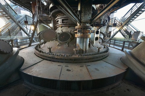 Rusty industrial machine with complex gears and mechanical parts in an old industrial plant,