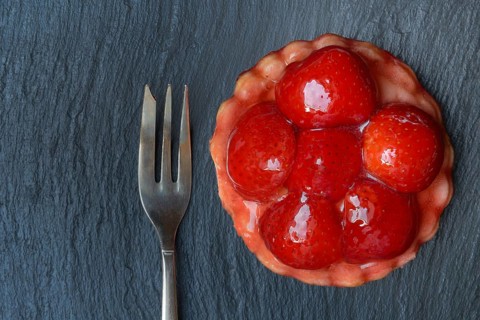 Topped strawberry tartlet with fork