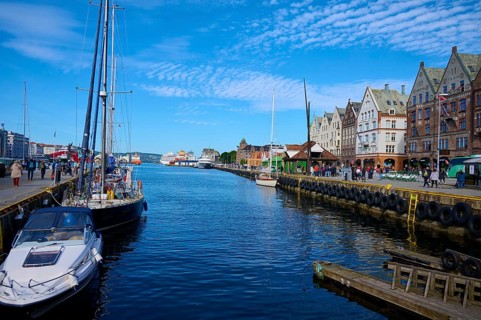 Picturesque harbour with boats, historic buildings, blue sky, Bryggen, Bergen, Vestland, Norway,