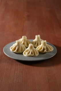 Georgian boiled dumplings, khinkali stuffed with lamb or beef minced meat on a plate