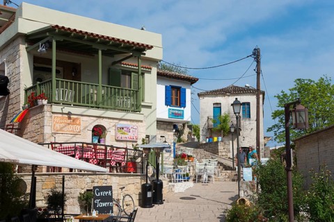 Charming Greek village with traditional tavernas and colourful houses under a clear sky, Afytos,