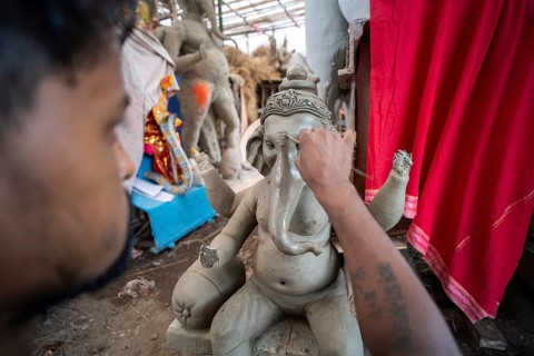 Artisan work on idols of the elephant-headed Hindu deity Ganesha at a workshop ahead of the Ganesh