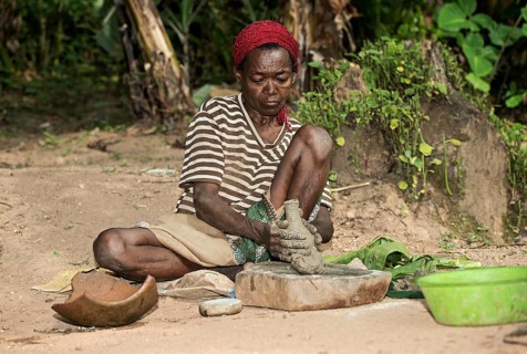 Woman from the Ari ethnic group making pottery on a pottery slab, Southern Omo Valley, Ethiopia,