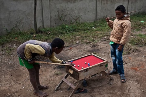 Two boys are playing billiards at Fianarantsoa, Madagascar, Africa