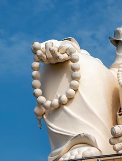 Close-up of the statue of Budai - Laughing Buddha, Vinh Trang Temple, My Tho, Mekong Delta,