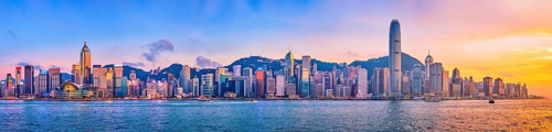 Panorama of Hong Kong skyline cityscape downtown skyscrapers over Victoria Harbour in the evening