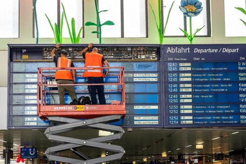 Technicians working on an electronic information board, display board for train connections at