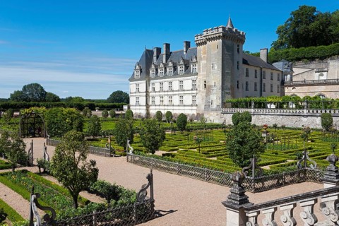Historic castle surrounded by an overgrown garden with hedges and well-tended paths, Villandry