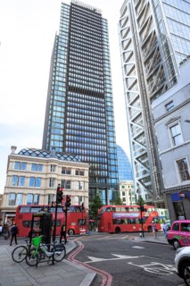 Skyscrapers and red double-decker buses in a busy street scene in the city of London, United