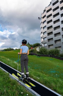 CopenHill, waste incineration plant and artificial ski slope, skiing with a view of the ski lift,