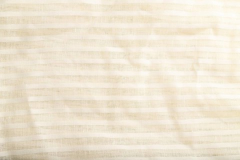 Fragment of smooth white linen tissue. Top view, flat lay, natural textile background and texture