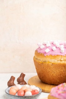 Homemade glazed and decorated easter pies with chocolate eggs and rabbits on a white concrete