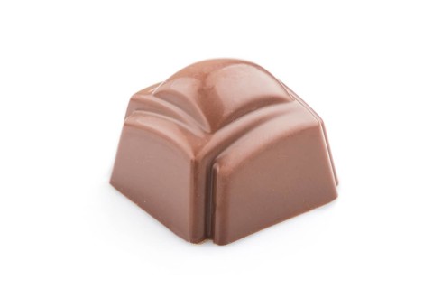 Single chocolate candy isolated on white background. side view, close up