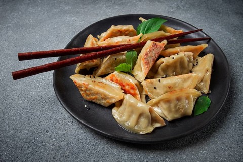 Japanese fried dumplings, gyoza, sesame seeds, top view, no people