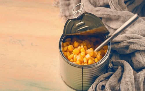 Open tin can, with corn, top view, selective focus, no people, close-up
