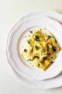 Ravioli with spinach and cheese, green sauce, on a light background, selective focus, no people