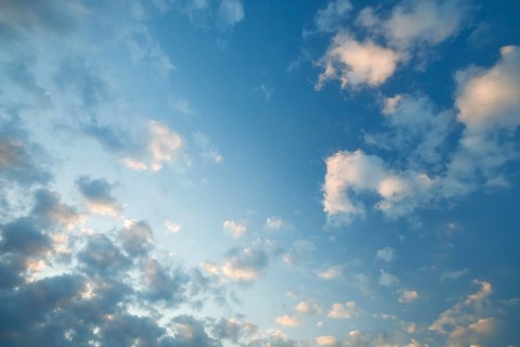 Fleecy clouds adorn the blue evening sky