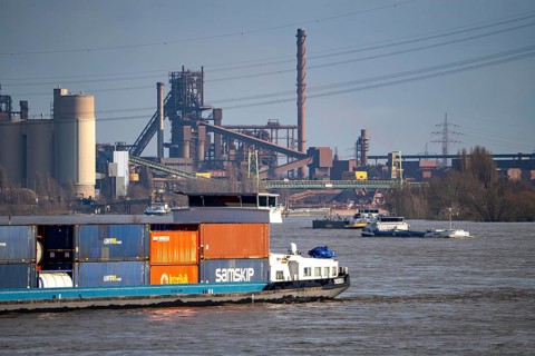 The Rhine near Duisburg, cargo ships, backdrop of the ThyssenKrupp Steel steelworks in Duisburg