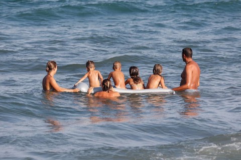 Families with children on an air mattress on the beach of Diano Marina, Italy, 14/08/2024, Diano