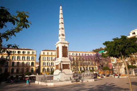 People enjoying a sunny spring afternoon in Plaza de la Merced, Malaga Spain