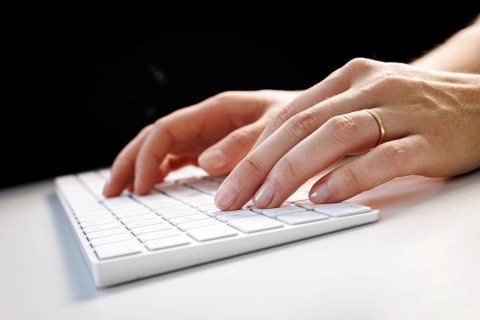 Hands typing on a keyboard in Berlin, 09/08/2024
