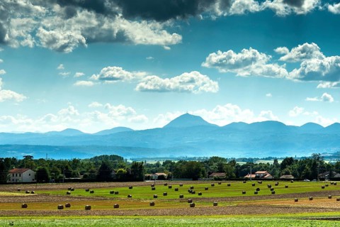 View of the Chain of Volcanoes and Limagne plain under a vibrant sky in Puy-de-Dôme,