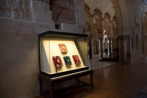 Glass display case of historic bible books inside the cathedral, former Great mosque, Cordoba,