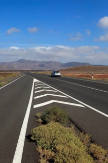 Chevron road lines on main highway through Malpaís Grande national park, Fuerteventura, Canary