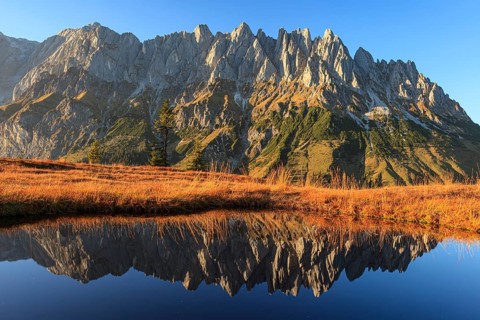 Rugged mountains reflected in a small mountain lake, autumn, evening light, Hochkönig, Mandlwand,