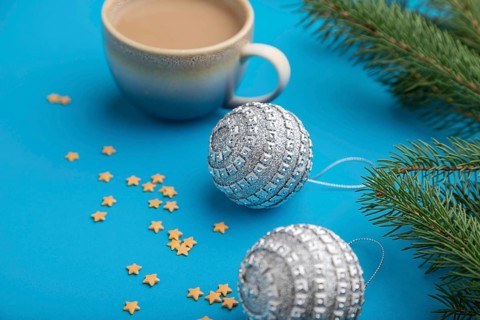 Christmas or New Year composition. Decorations, silver balls, fir and spruce branches, cup of