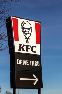 Banner sign Colonel Sanders advertising KFC Kentucky Fried Chicken Drive Thru outlet, Martlesham,