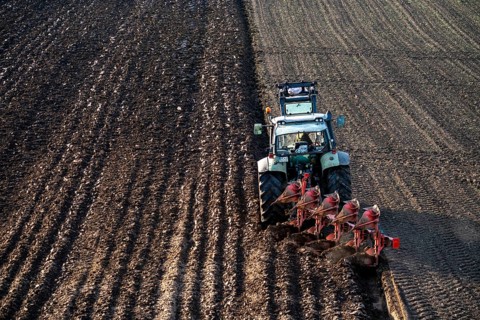 Farmer ploughing a field, tractor with plough, near Neuss, North Rhine-Westphalia, Germany, Europe